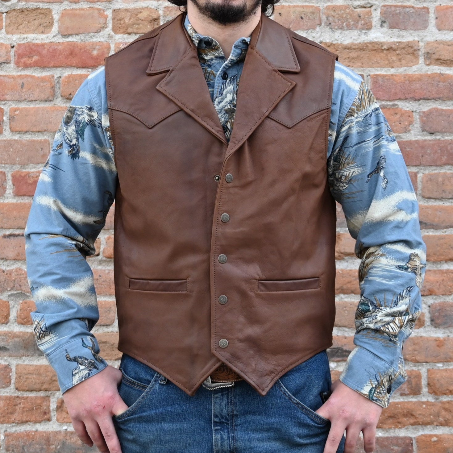 View of Schaefer whiskey-colored leather vest with Western yoke design, lapel front, and dual pockets