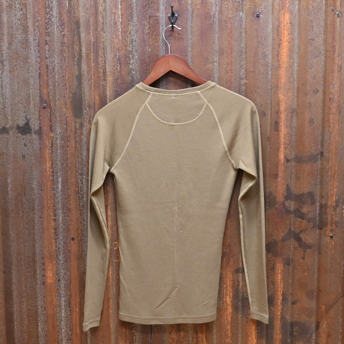 View of Filson Ladies 280g Merino Long Sleeve Crew in Rugged Tan, showcasing its soft merino wool fabric for warmth and comfort