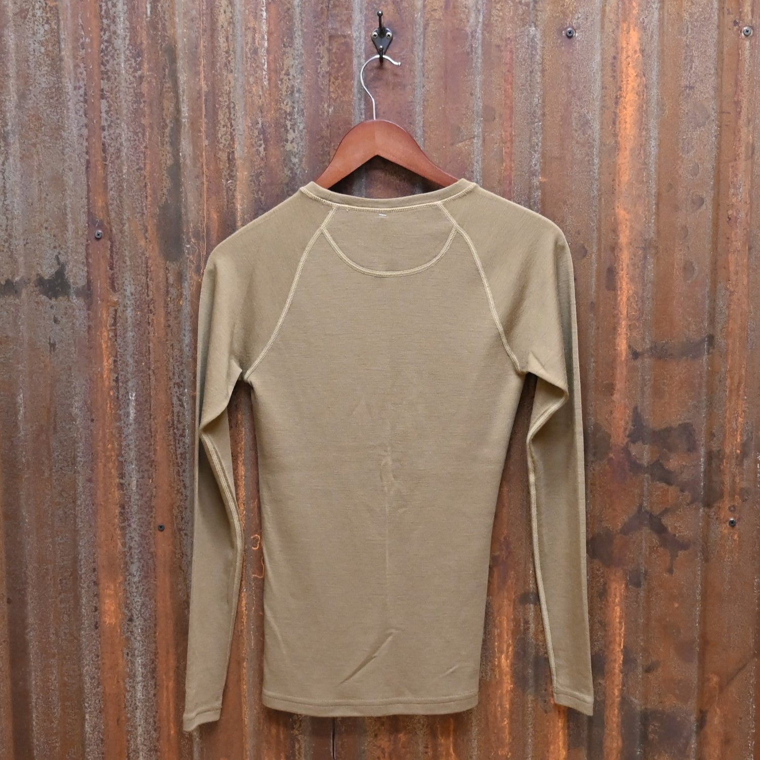 View of Filson Ladies 280g Merino Long Sleeve Crew in Rugged Tan, showcasing its soft merino wool fabric for warmth and comfort