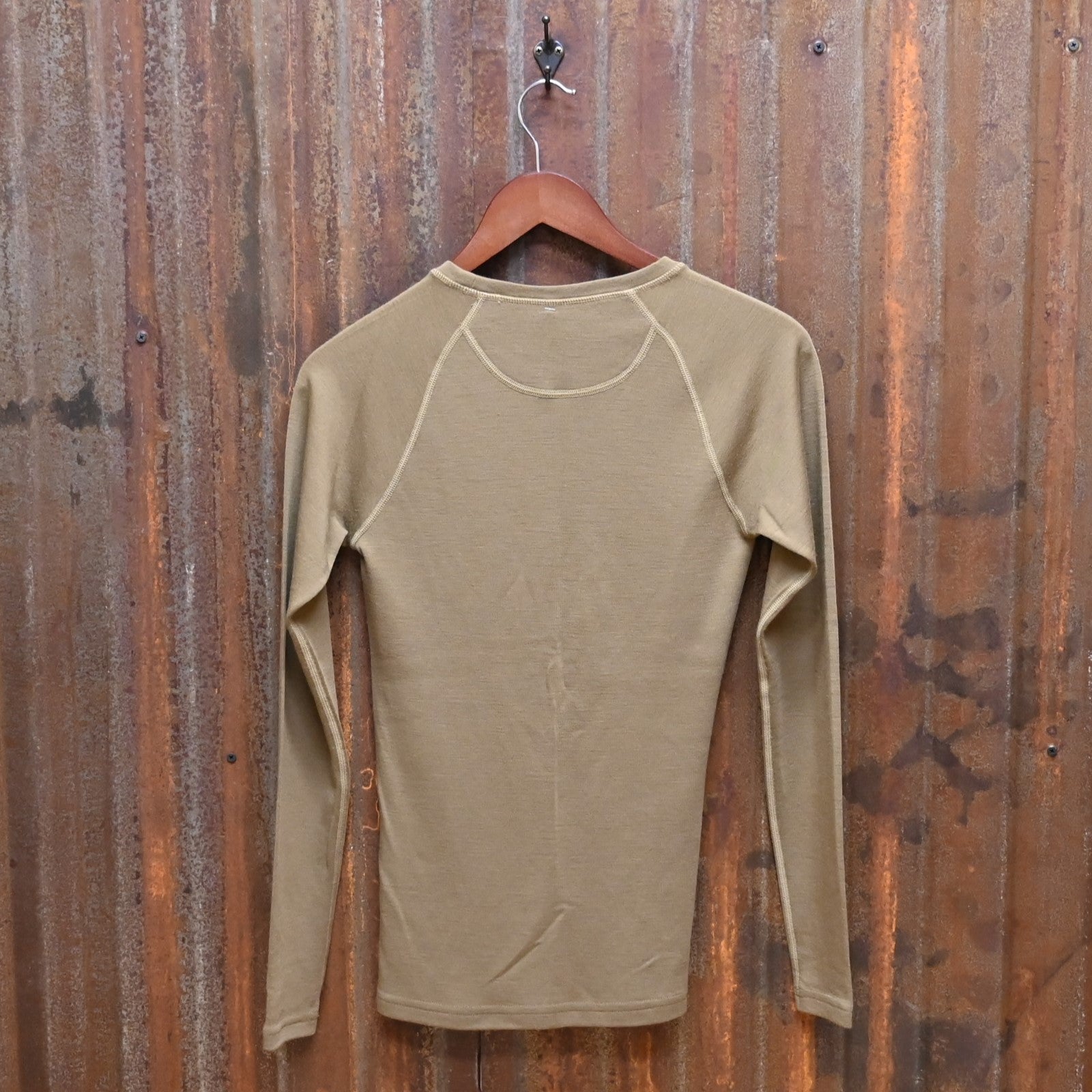 View of Filson Ladies 280g Merino Long Sleeve Crew in Rugged Tan, showcasing its soft merino wool fabric for warmth and comfort
