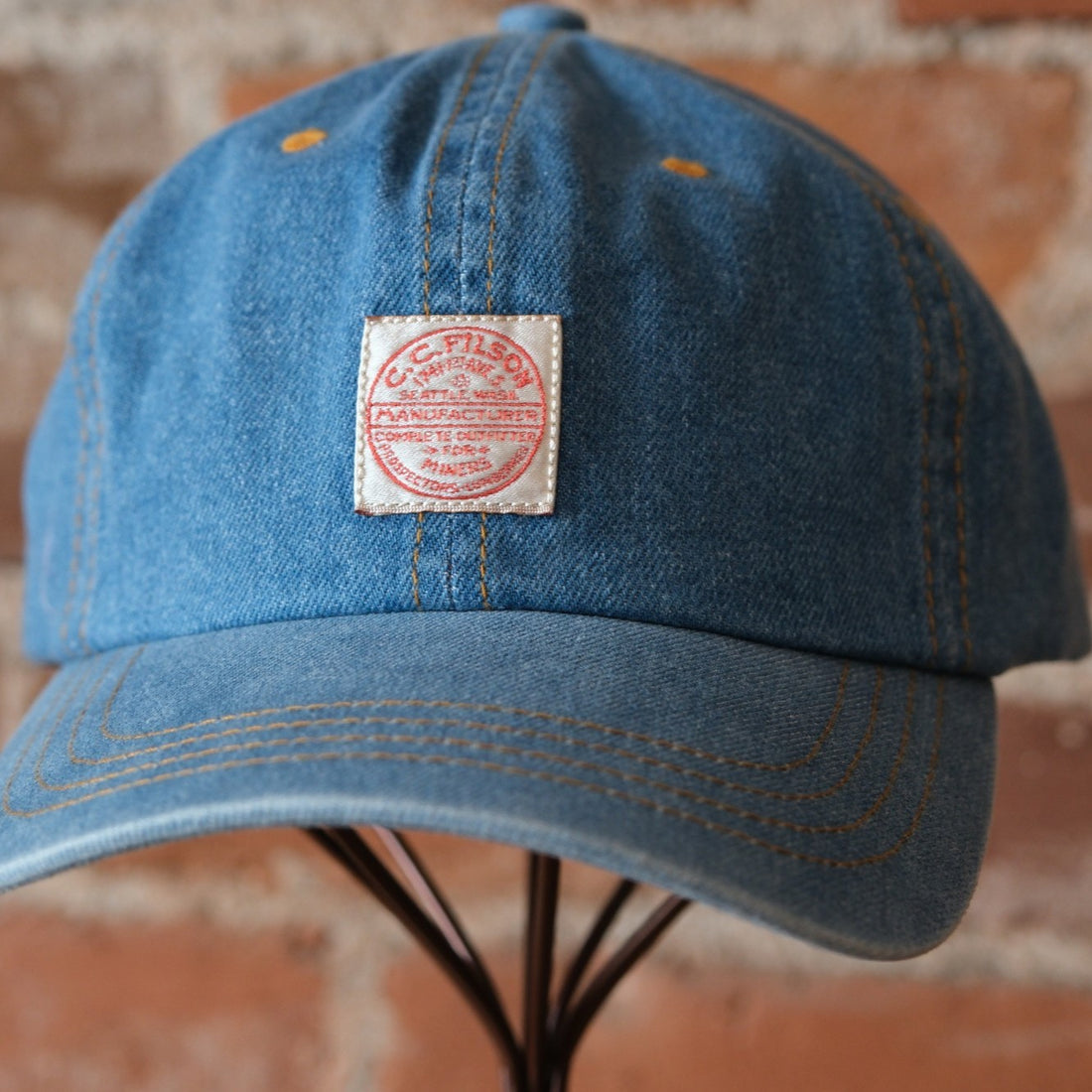 Filson 9.5-oz. Denim Cap in Medium Indigo featuring a 6-panel design and vintage Filson logo patch.