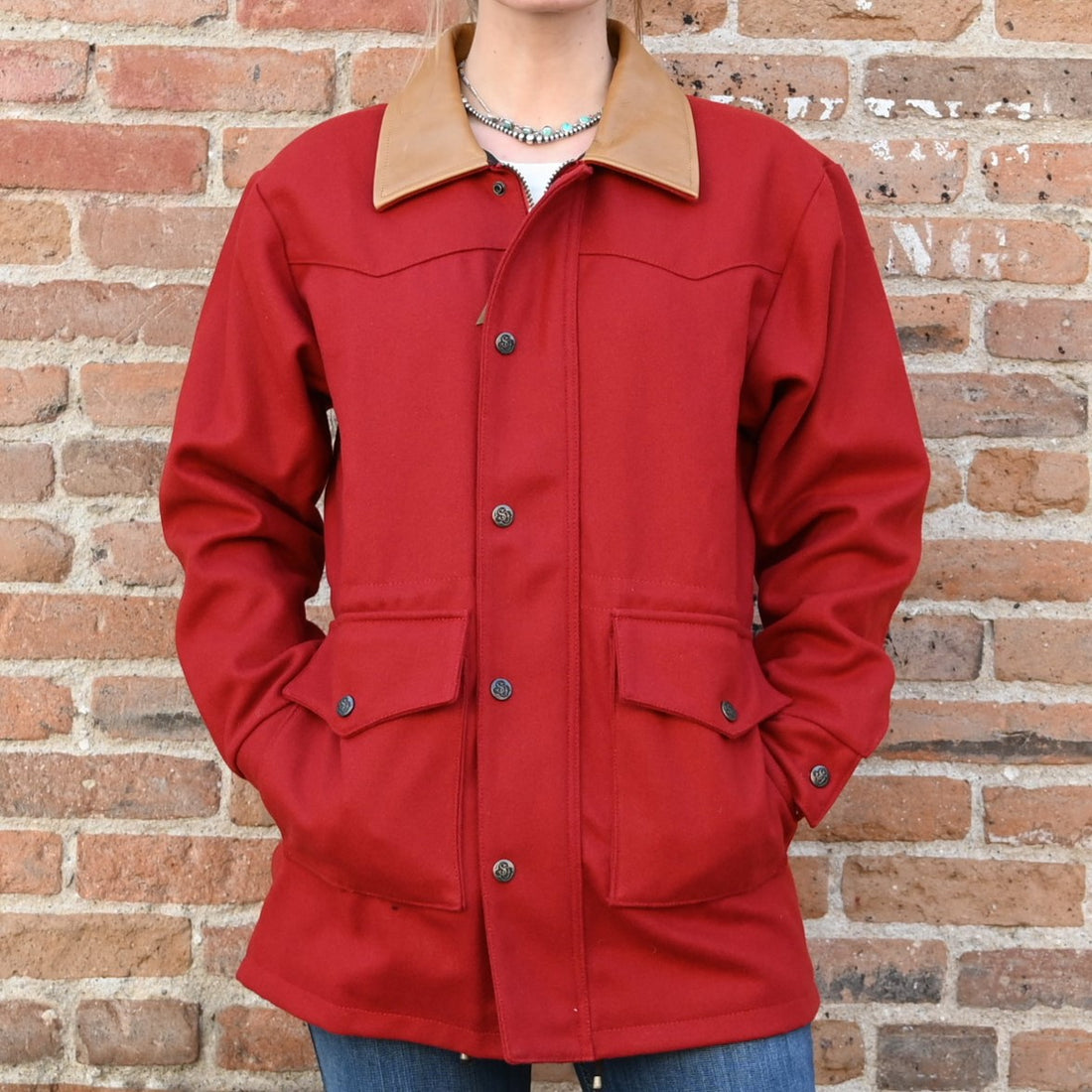 View of Schaefer ladies red wool rancher coat with leather collar, snap vents, and drawcord waist