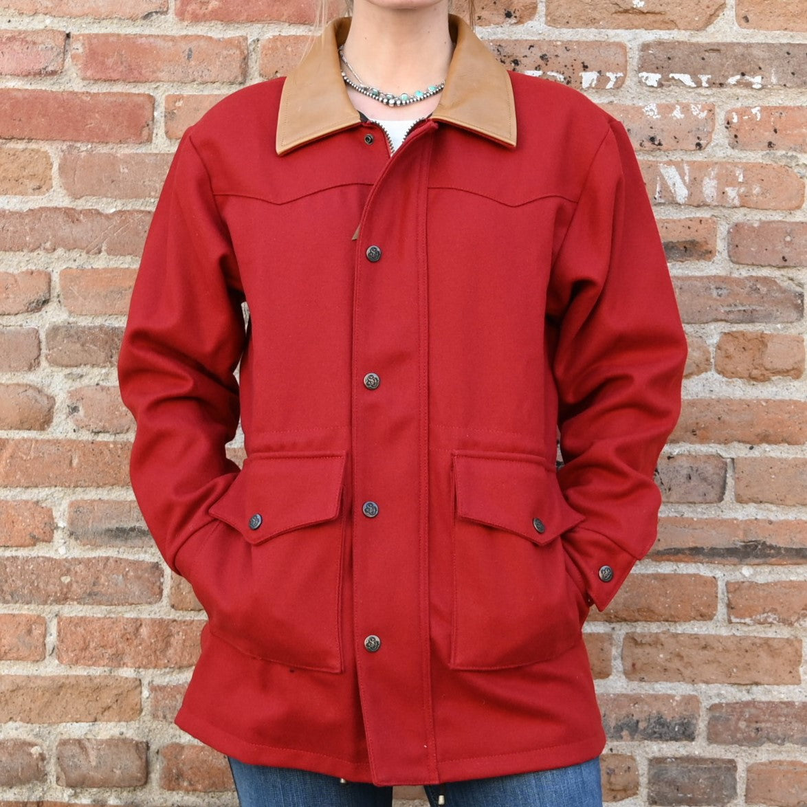 View of Schaefer ladies red wool rancher coat with leather collar, snap vents, and drawcord waist