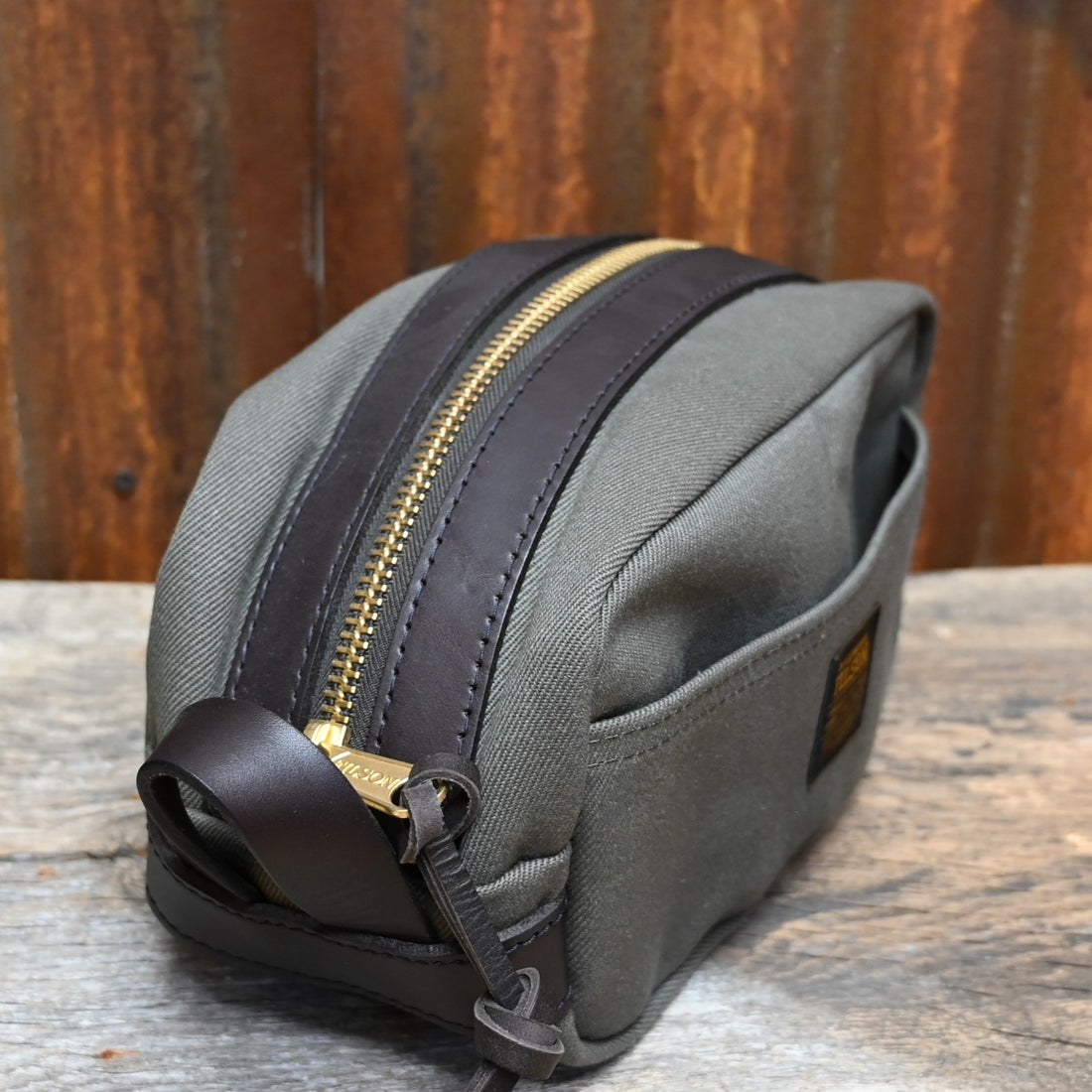 View of Filson Lightweight Travel Kit with Leather Loop in Otter Green featuring Bridle Leather accents and waterproof nylon lining