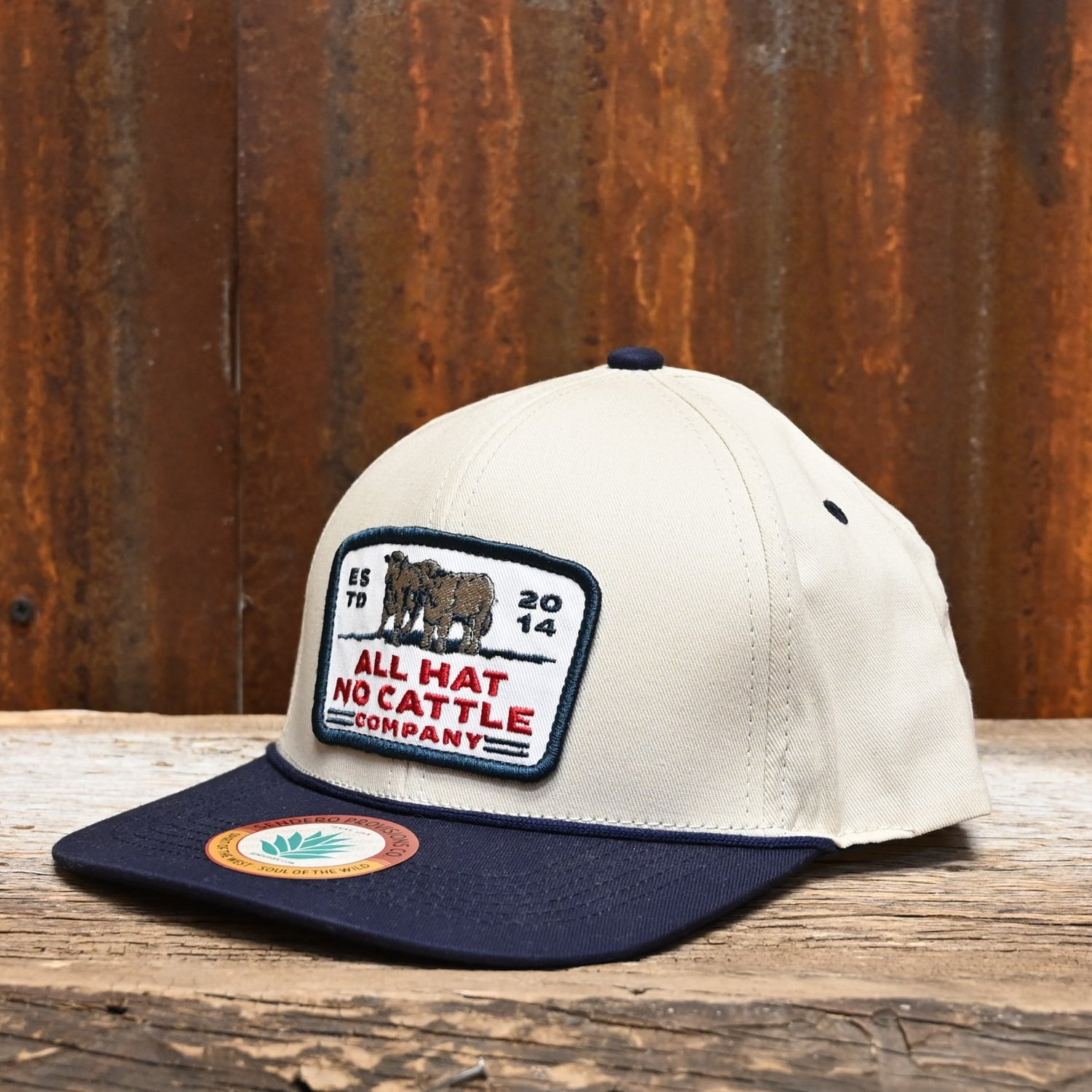 View of Sendero “All Hat No Cattle” white hat with black embroidery and snapback closure