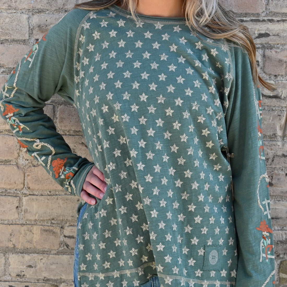 View of Double D Ranch Cowboys Up My Sleeve Top – Button-down top in Garcitas Green with cowboy-inspired print and a relaxed, flattering fit