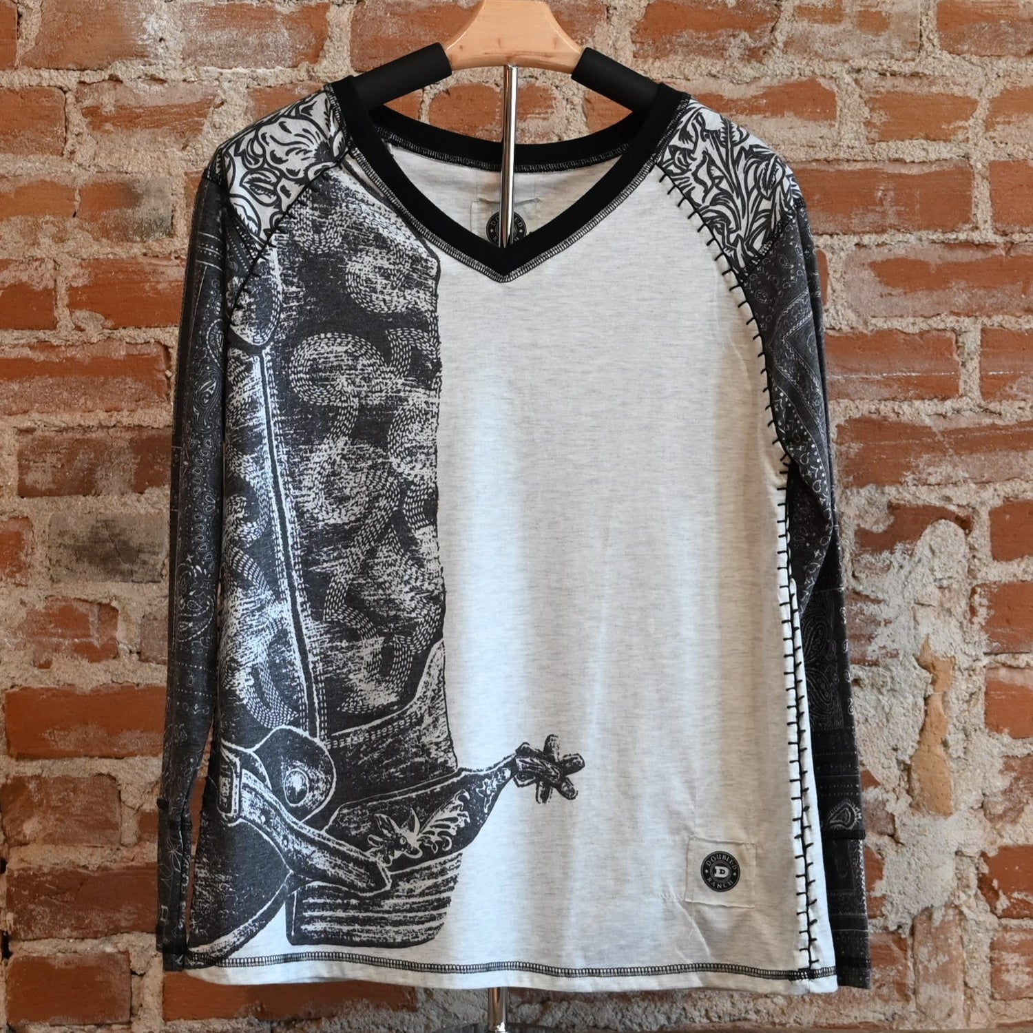 View of Double D Ranch Hide Tickler Top – Silver Spur top with spurred cowboy boot graphic and bandana-patterned sleeves for a Western-inspired look