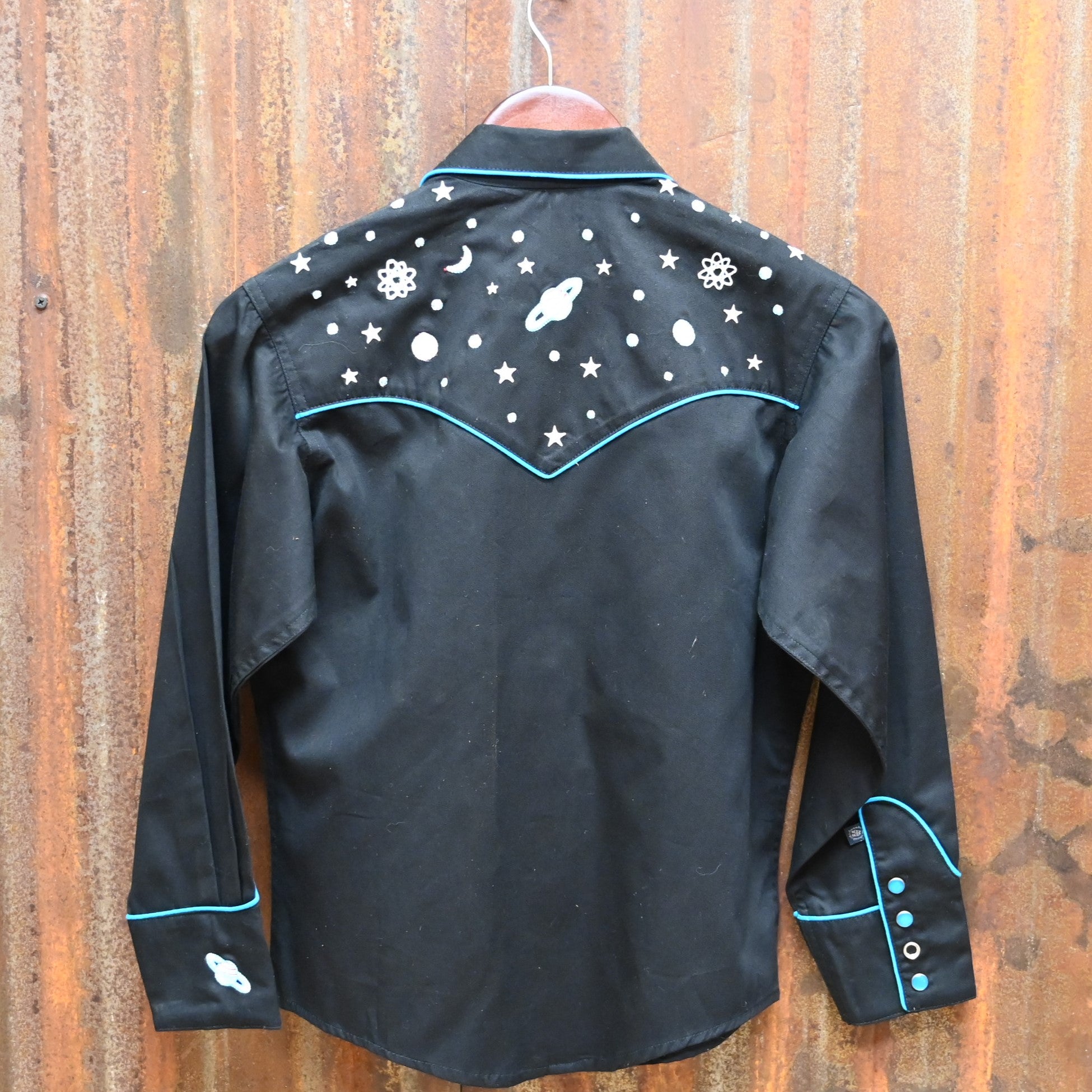 View of Black Rockmount kids western shirt size Large with embroidered stars, planets, and rockets