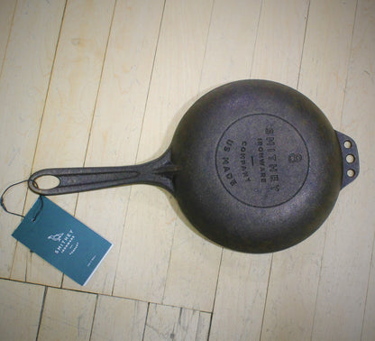 View of Smithey Ironware No. 8 Cast Iron Chef Skillet with polished interior and ergonomic handle