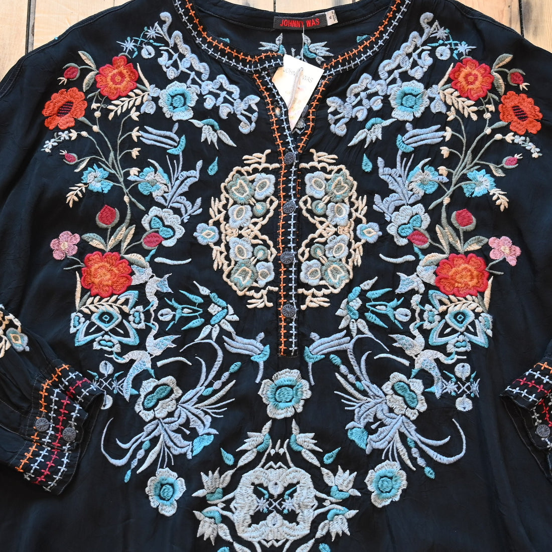 View of Johnny Was sanded black blouse with tonal embroidery on front and shoulders