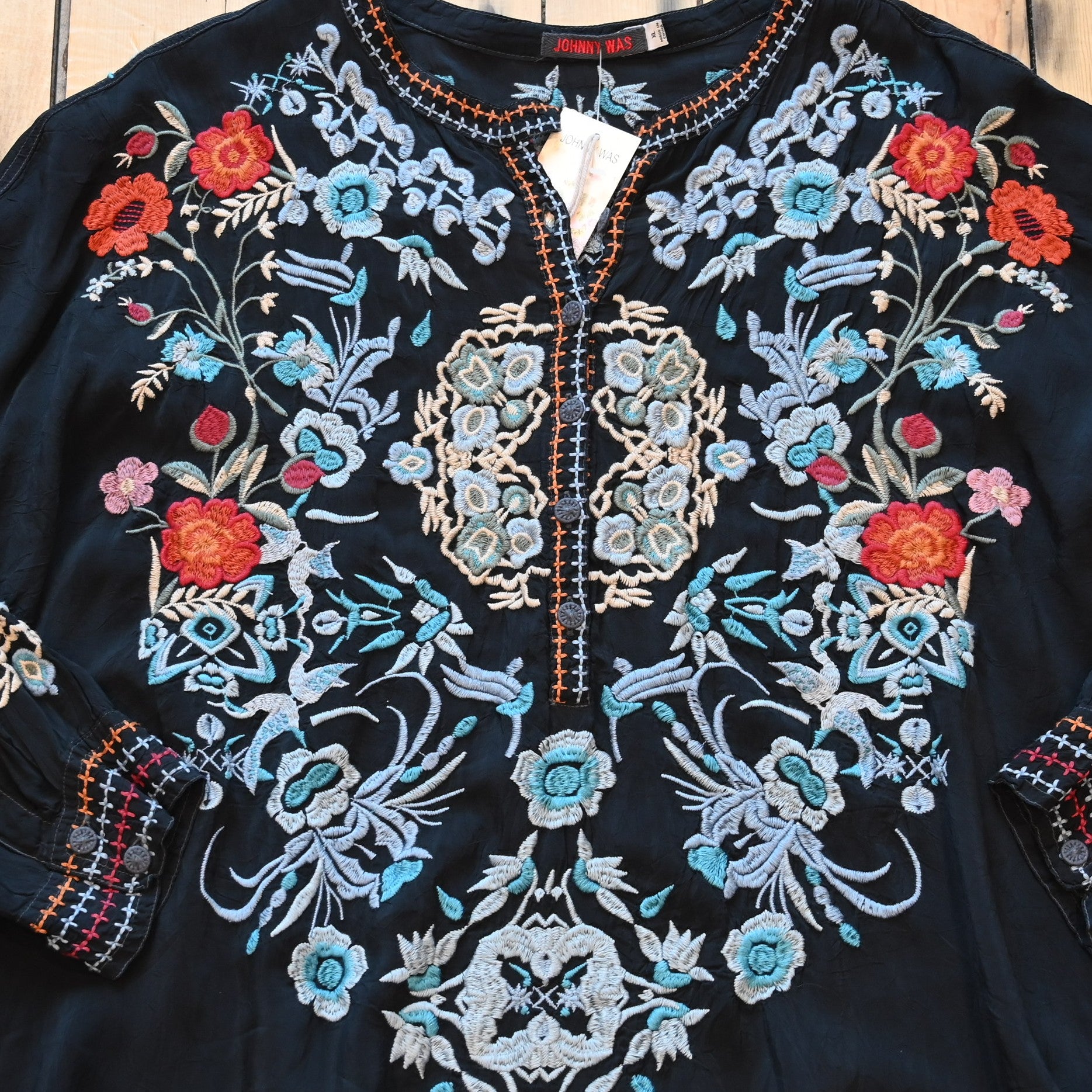 View of Johnny Was sanded black blouse with tonal embroidery on front and shoulders