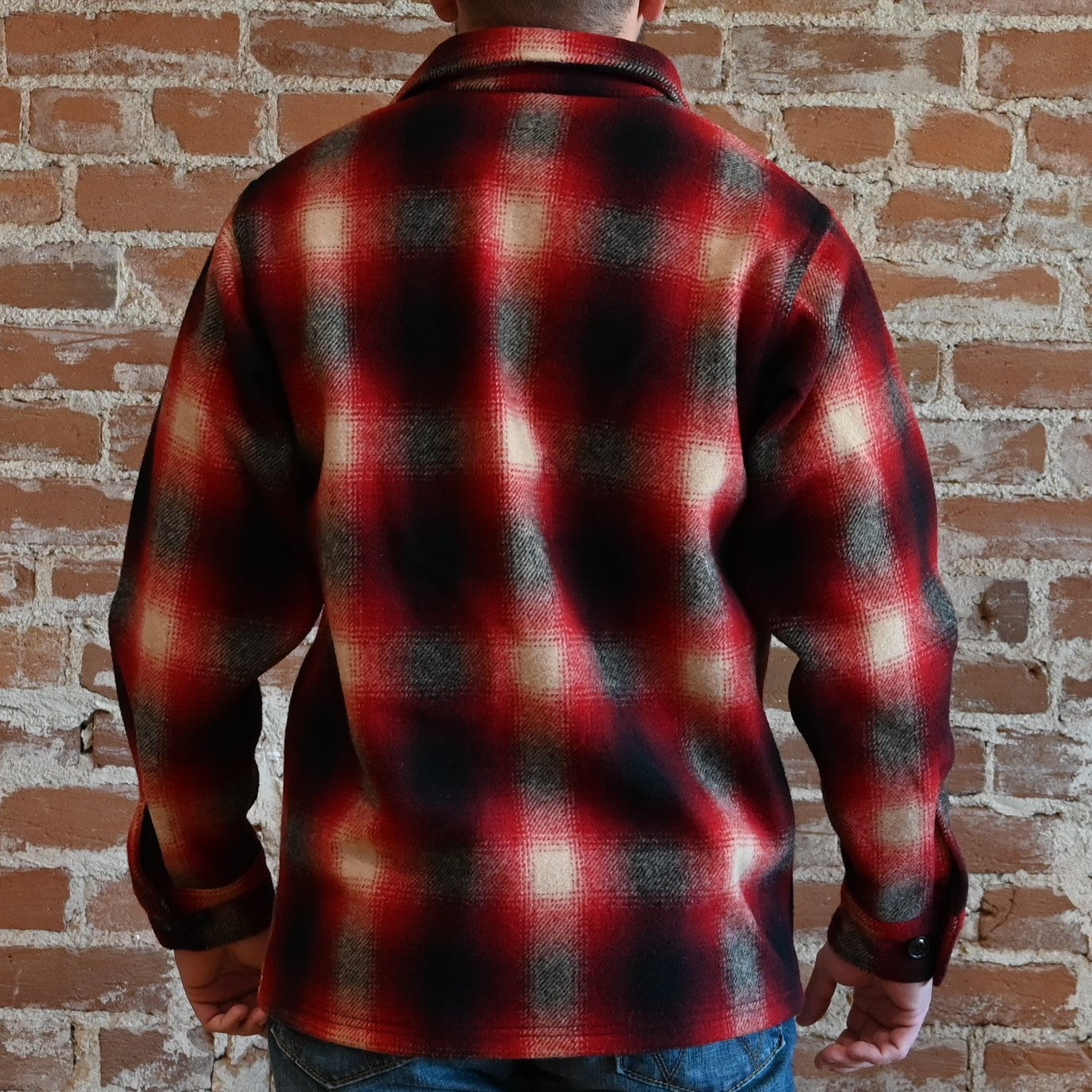 View of Filson Mackinaw Wool Jac-Shirt in Black Coffee Multi Plaid and Red/Black Ombre Plaid featuring button-front closure, adjustable cuffs, and hidden button-secured pockets
