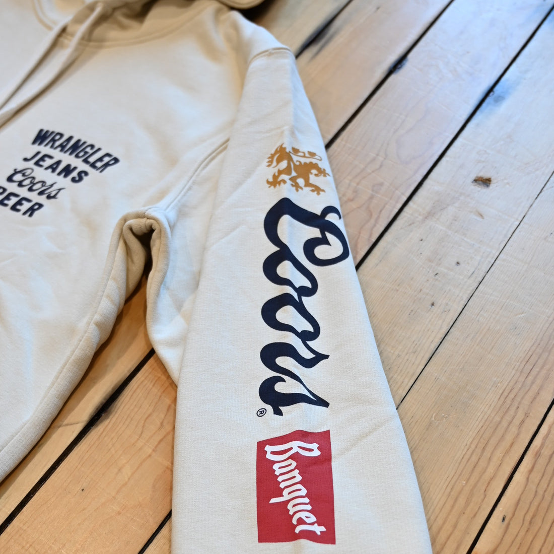 Wrangler × Coors graphic hoodie in antique white with logos down sleeves