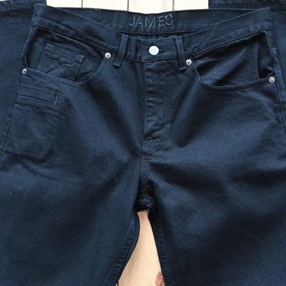 View of Kimes Ranch James Jeans in Black, showcasing straight-leg fit and integrated knife pocket