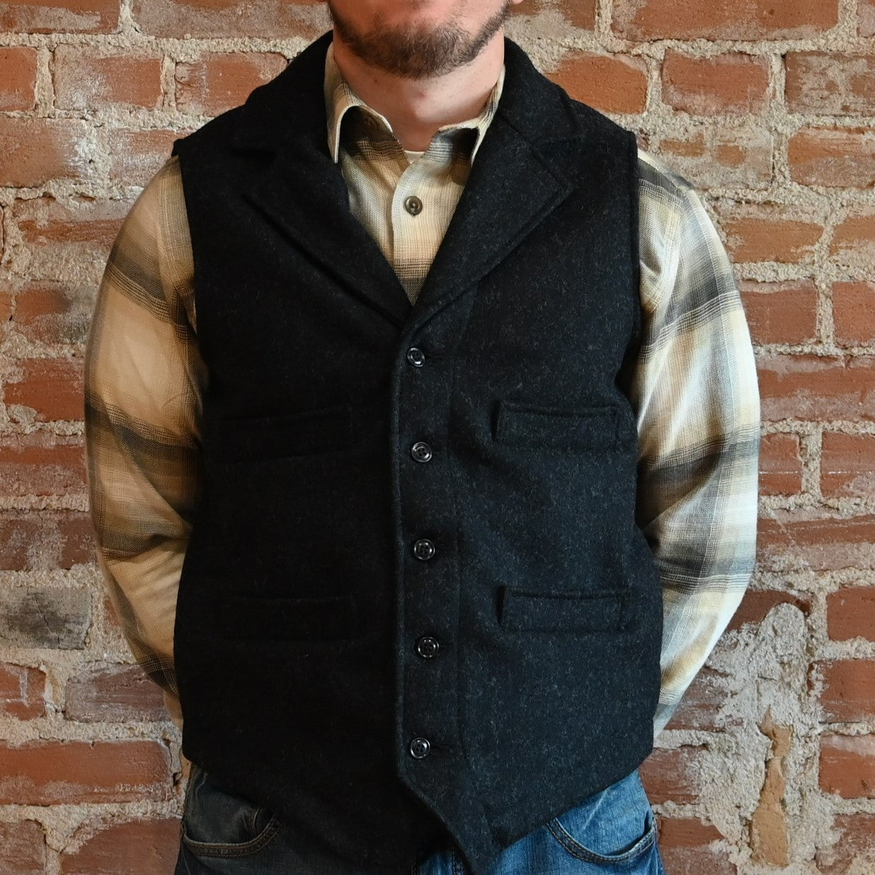 View of Filson Western Vest in Charcoal and Forest Green, showcasing its classic Western design and durable Mackinaw Wool construction