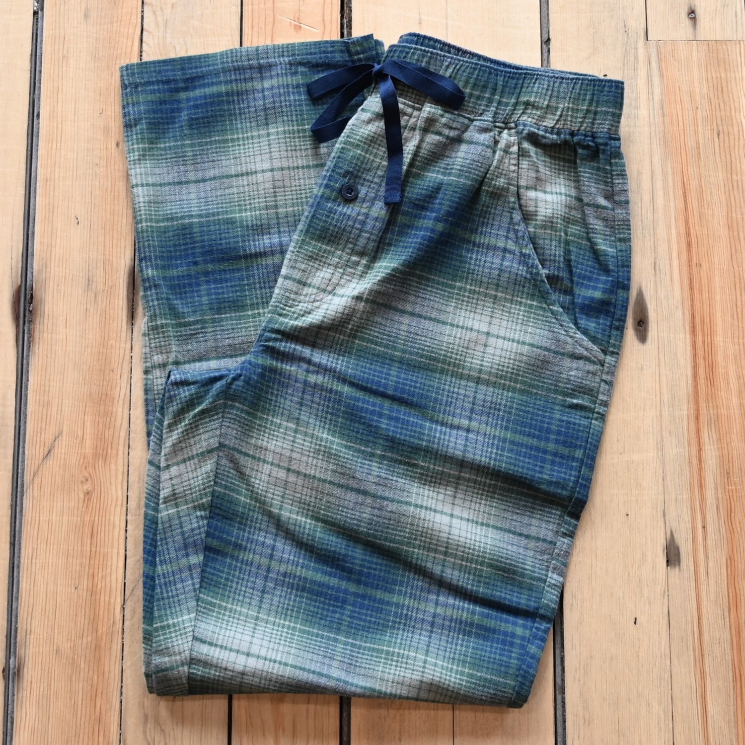 View of Pendleton men’s plaid cotton pajama pants in blue, green, and grey with elastic waist
