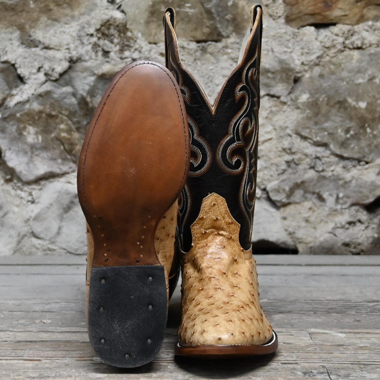 View of Hondo full quill umber ostrich boot with brown volcano top, medium round toe, and pull straps