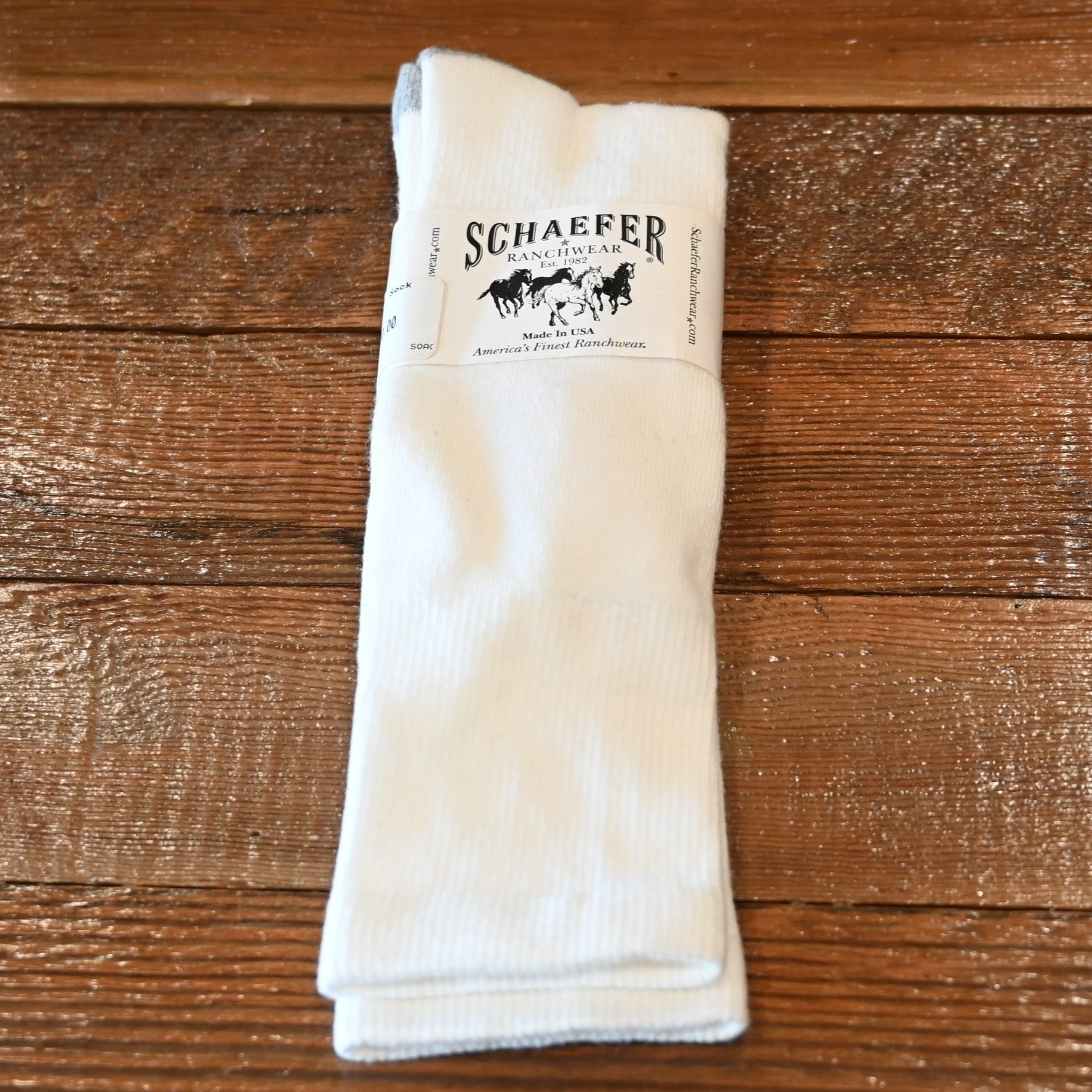 View of White over‑calf Schaefer Valley Wellington boot sock with cushioned foot and flat toe seam