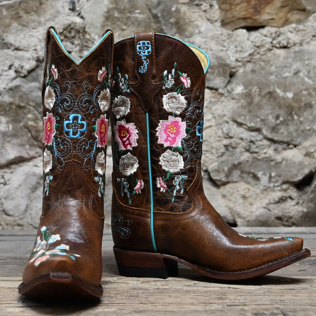 View of Macie Bean youth Honey Bunch boot with floral top, pointed toe, and cowgirl heel