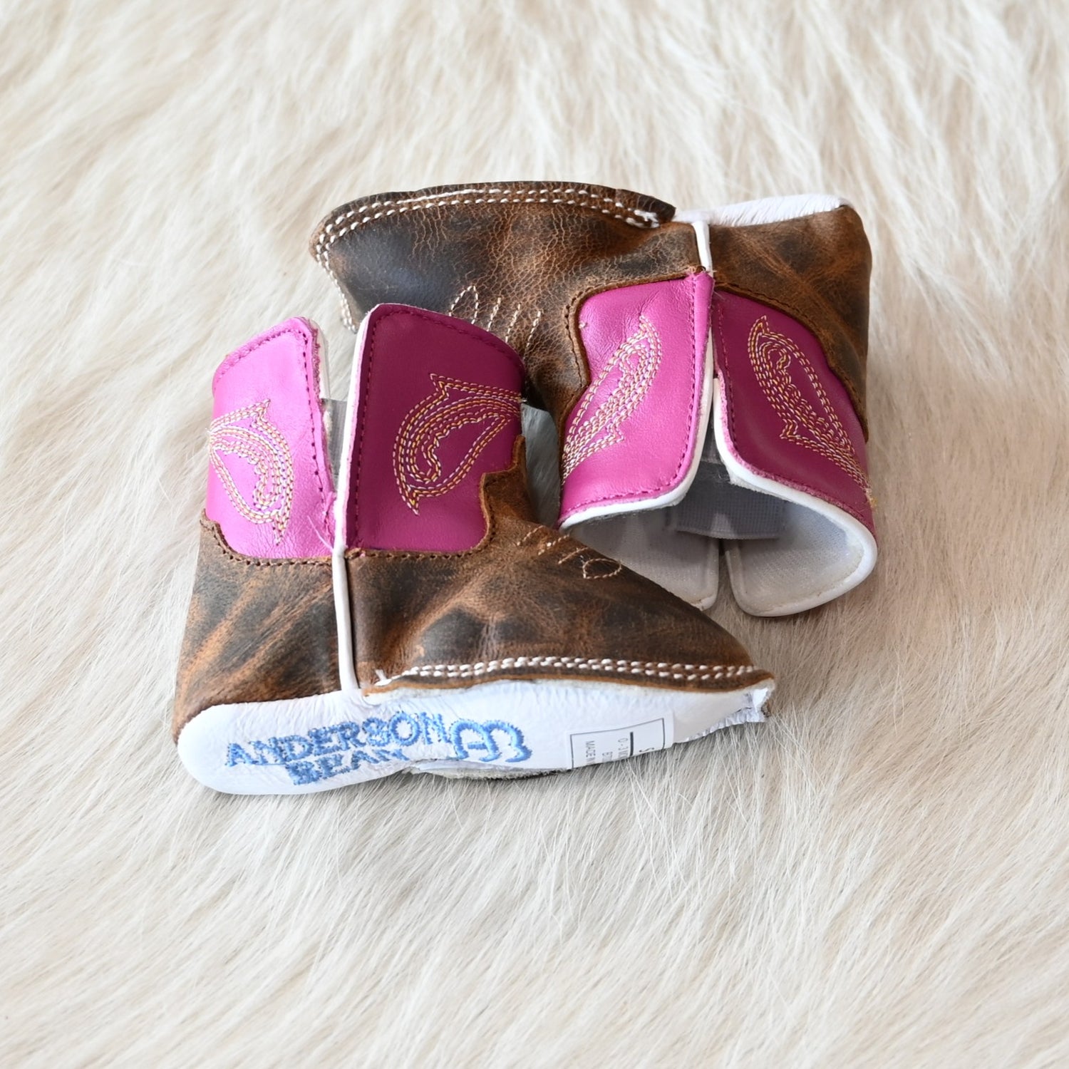 View of Anderson Bean Baby Bean boot with bone antique goat vamp, pink top, and soft sole