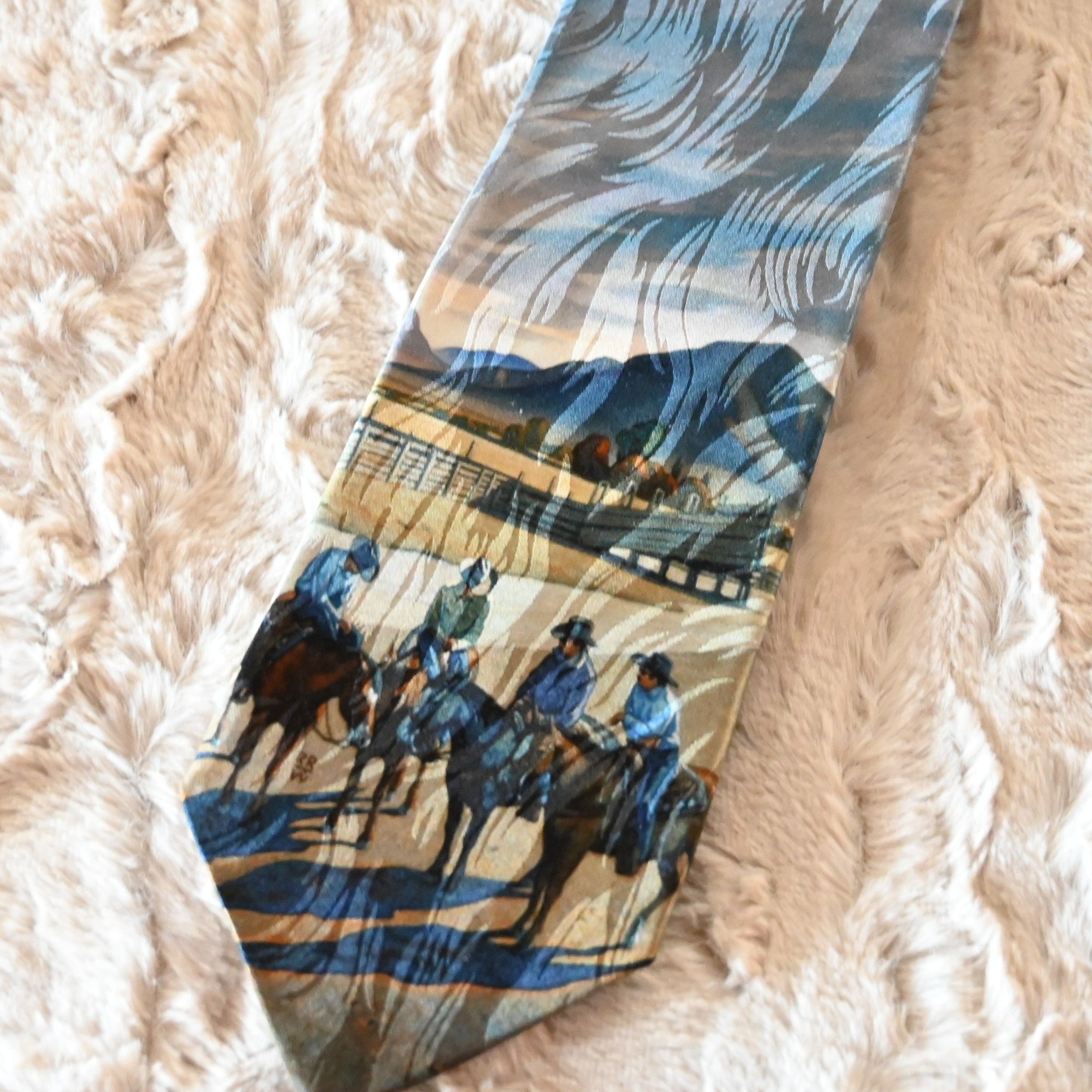View of Rockmount “Cattleman Conference” silk tie featuring cowboy scene by Howard Post
