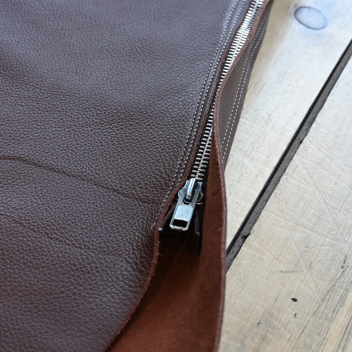 View of Weaver Shotgun Full Grain Chaps in brown oil-tanned leather with adjustable closures