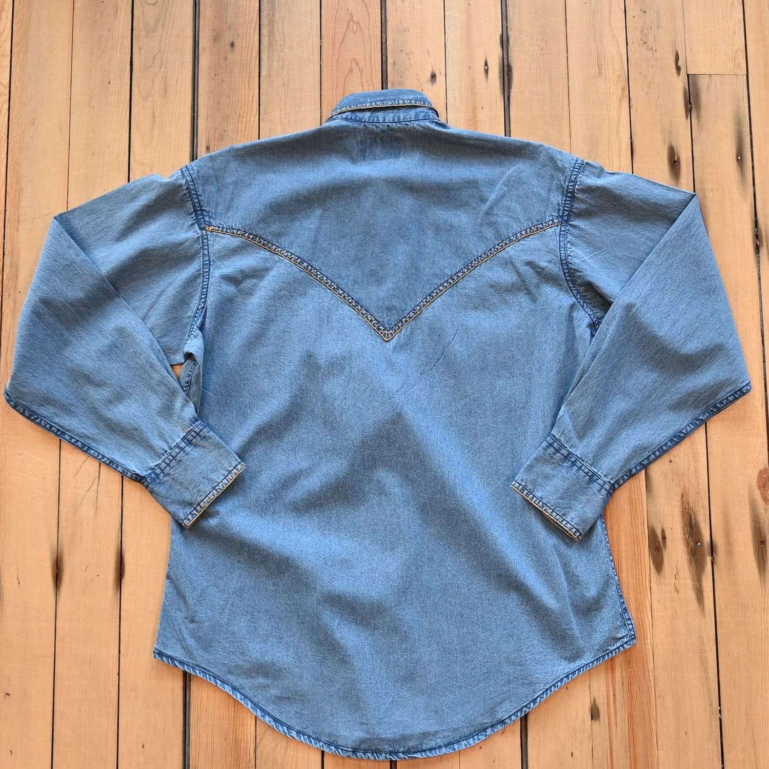 View of Rockmount men’s stonewashed denim Western shirt with blanket stitch detailing and snap front