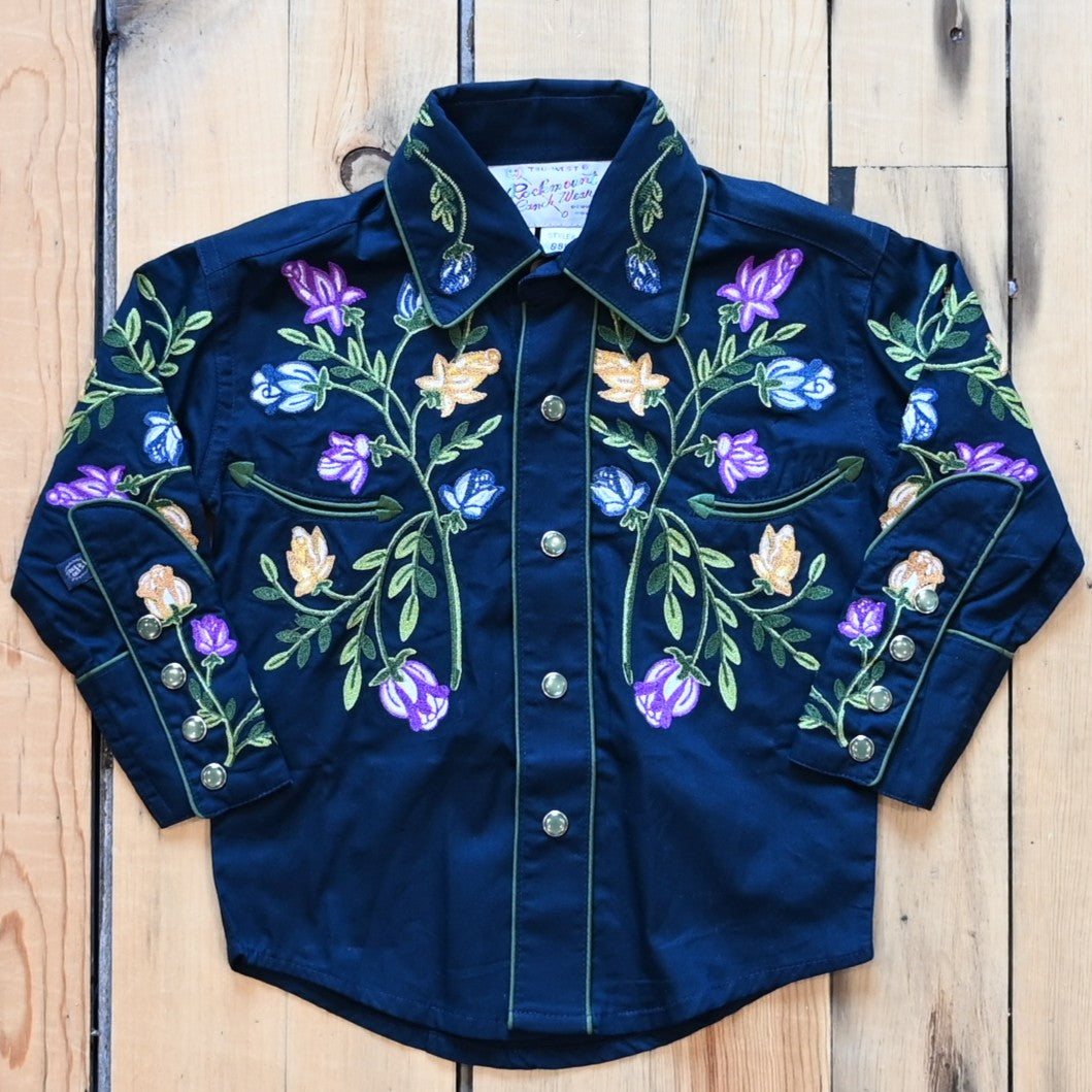 View of Rockmount kids navy shirt with embroidered crochet floral pattern, piping, and western detailing