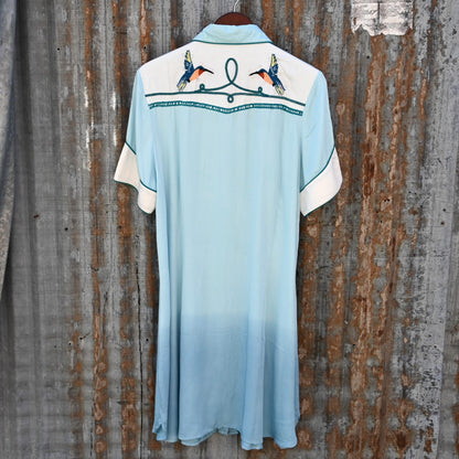 View of Double D Ranch Senoritas Rodeo Dress in Celestial Sky featuring embroidered floral print, pearl snap button closure, and drawstring waist