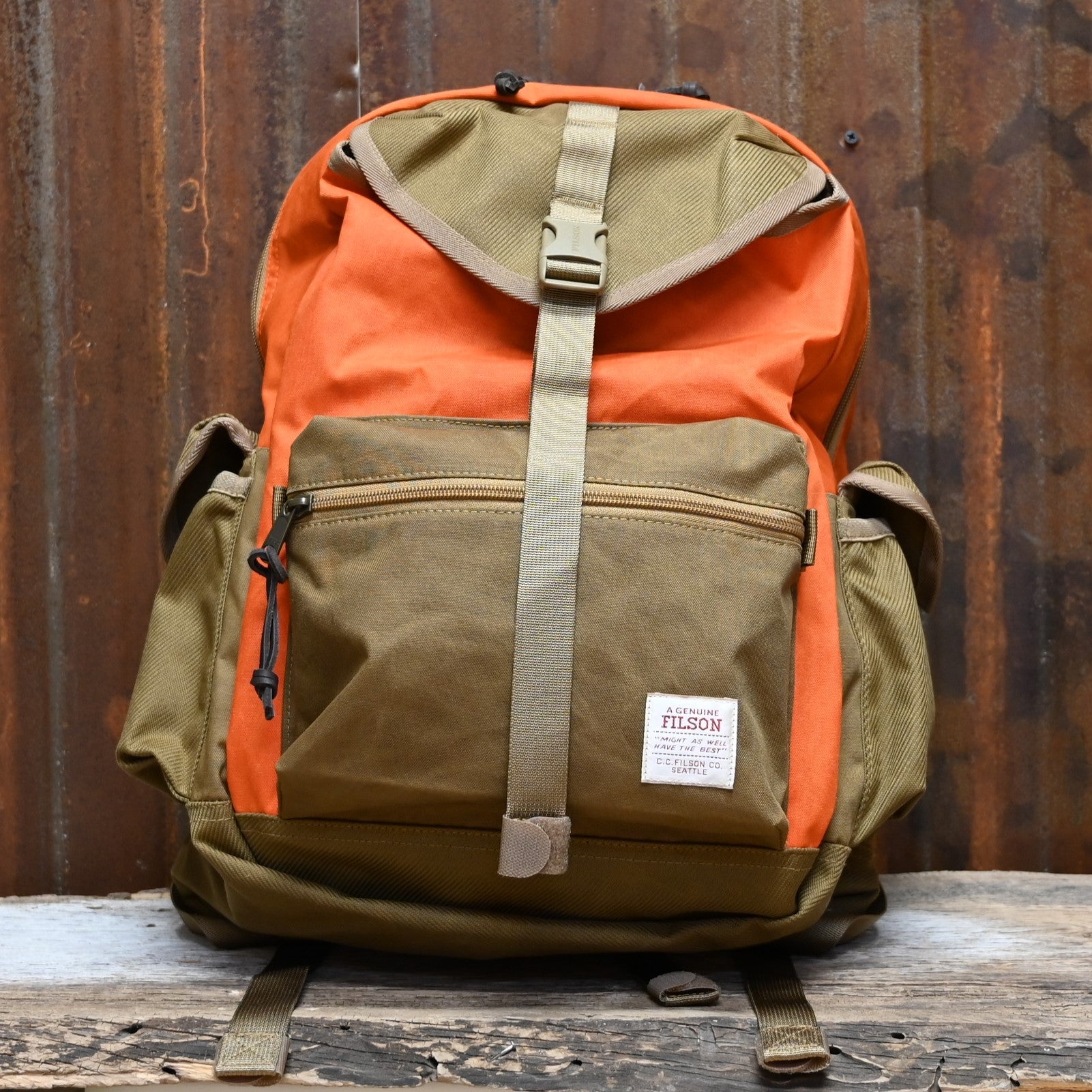 View of Filson Surveyor 36L Backpack in Dark Tan/Flame, featuring dry-waxed Cordura® nylon, padded laptop compartment, and multiple storage pockets