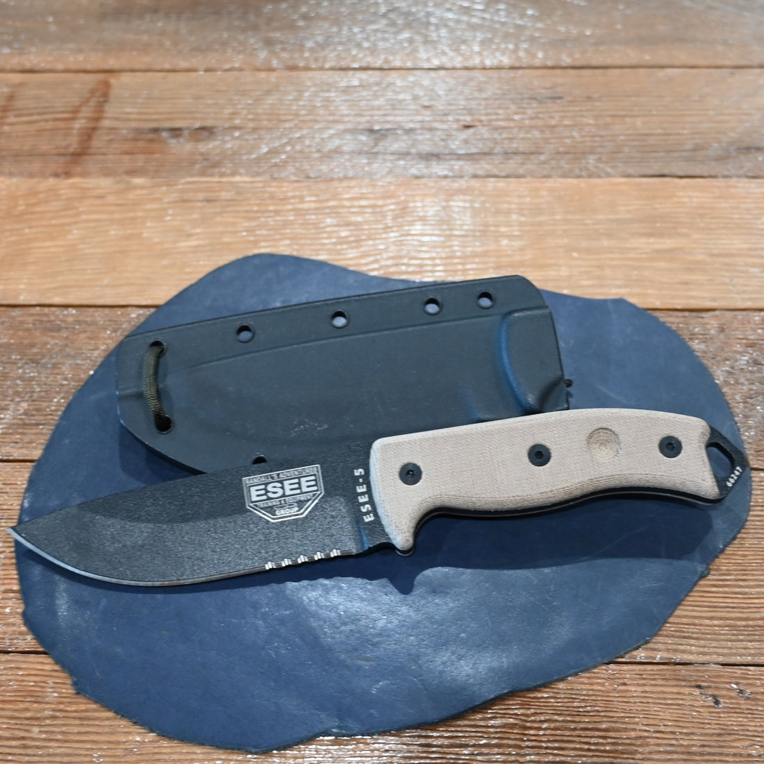 ESEE-5 serrated edge fixed blade knife with black coated blade, micarta handle, and MOLLE sheath