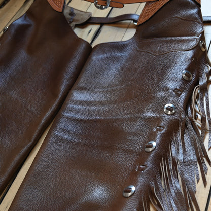 View of K Bar J Puncher Versatility Chap in Size Large with basket weave tooling and slotted conchos