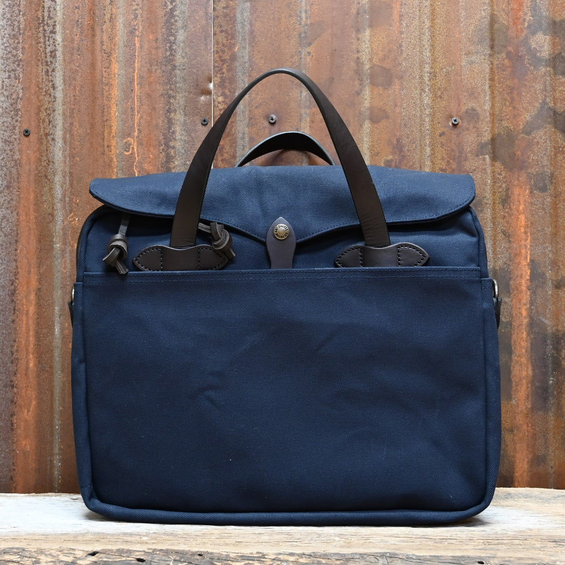 View of Filson Original Briefcase in Navy, showcasing rugged twill fabric and bridle leather accents