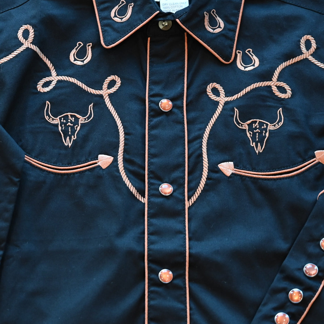 View of Rockmount Kids black western shirt with steer, horseshoe, and rope embroidery