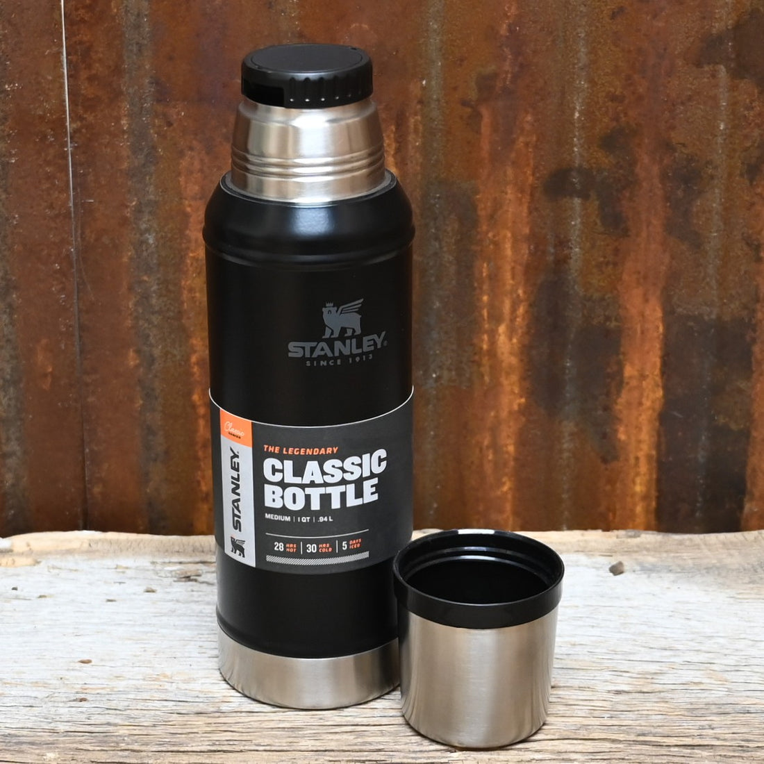 Stanley Classic Vacuum Bottle in matte black with twist-and-pour stopper, carry handle