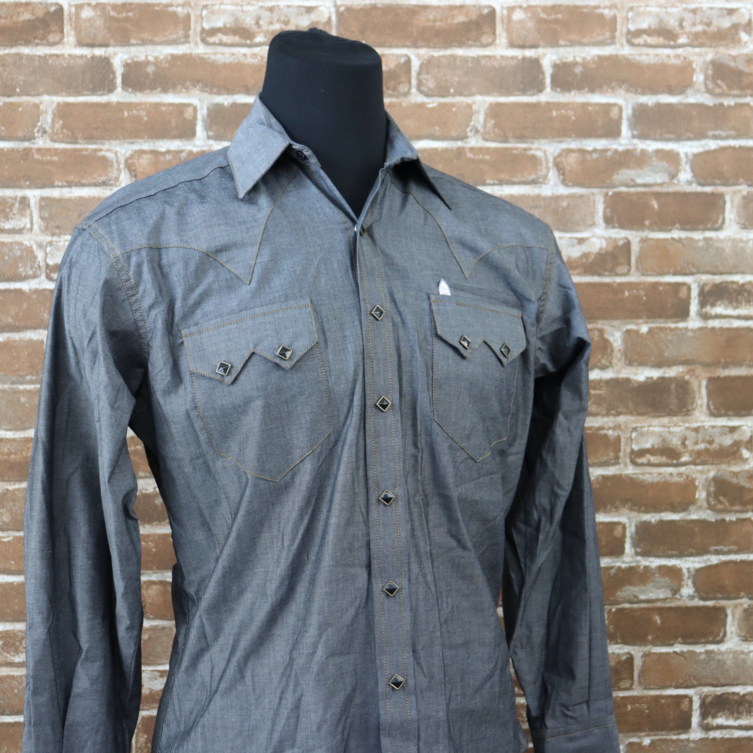 View of Rockmount black chambray western shirt with sawtooth pockets and gold diamond snaps