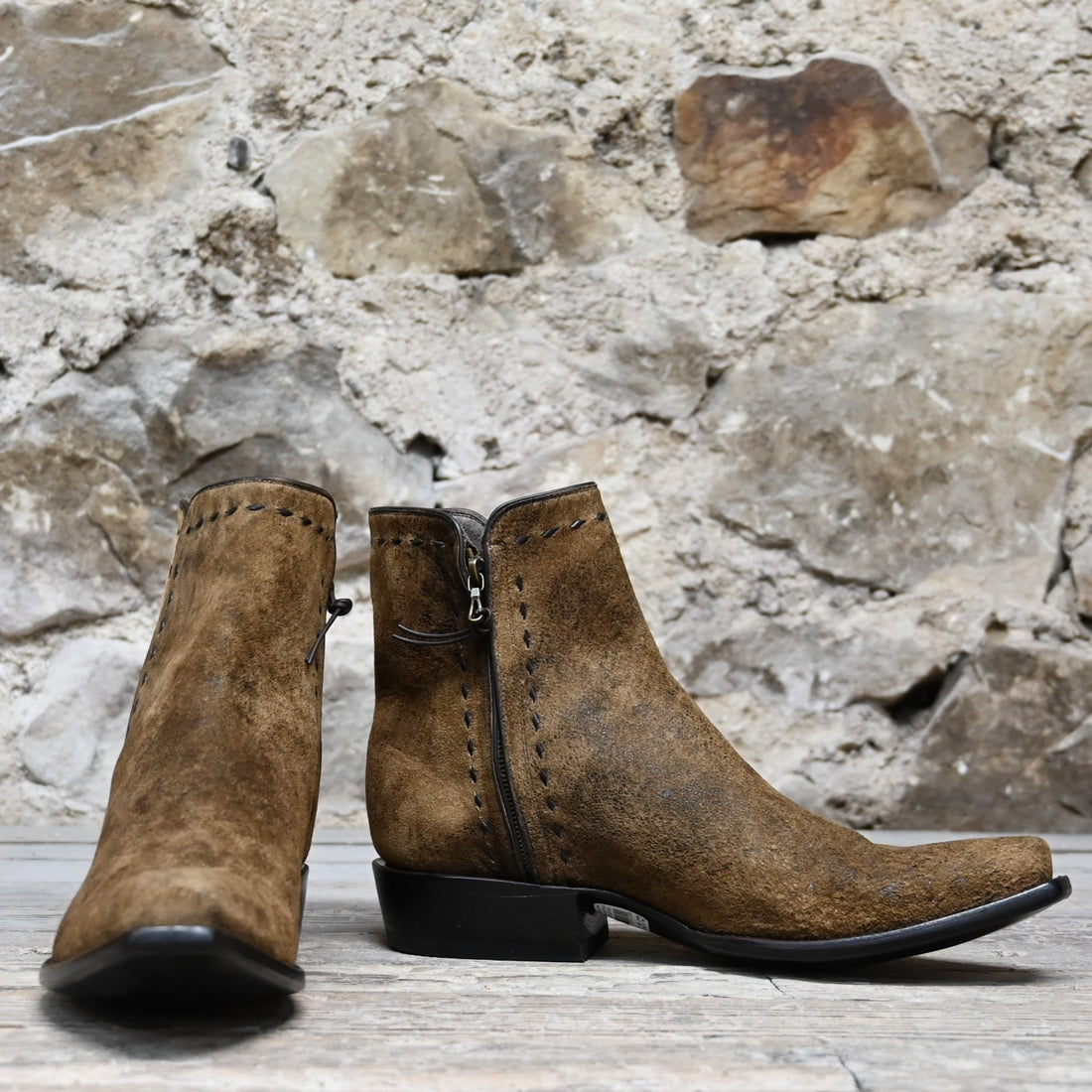 View of Stallion snip‑toe ankle boot in distressed camel kid with chocolate buckstitching and side zipper