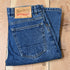 View of Blue Blanket men’s medium indigo straight-leg denim jeans with leather patch