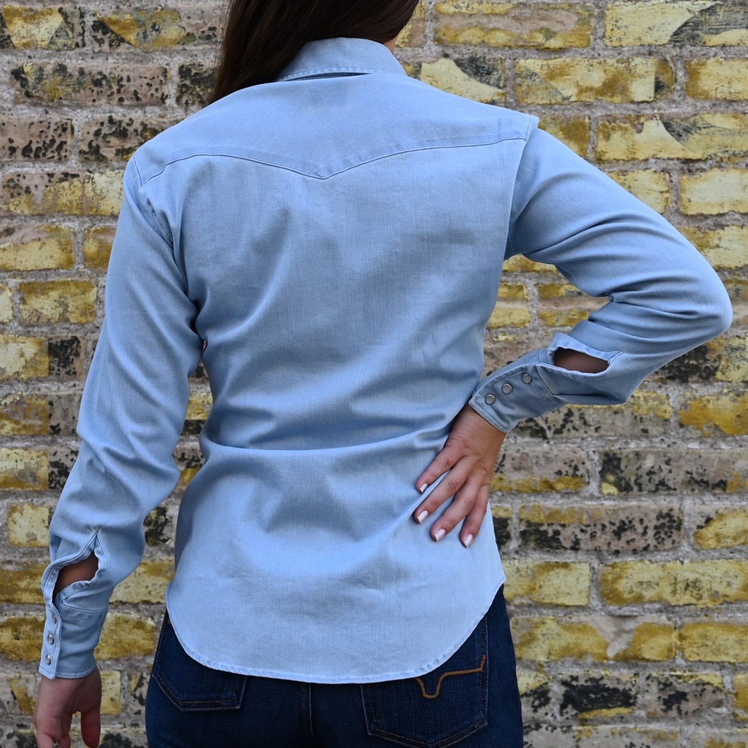 View of Blue Blanket ladies light denim Western shirt with pearl snaps, curved hem, and yoke