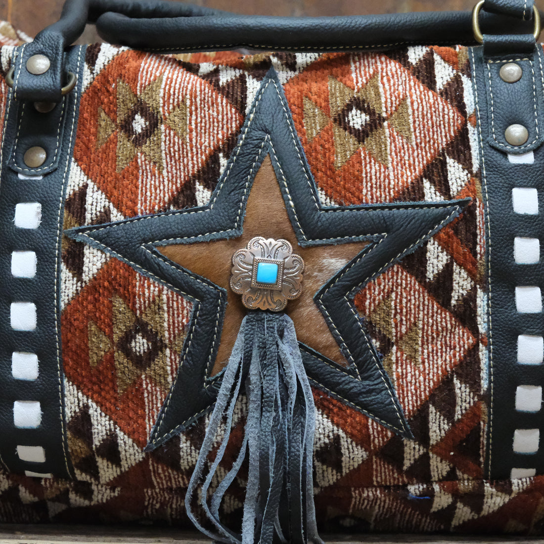 American Darling rust star canvas duffel bag with leather trim and turquoise concho
