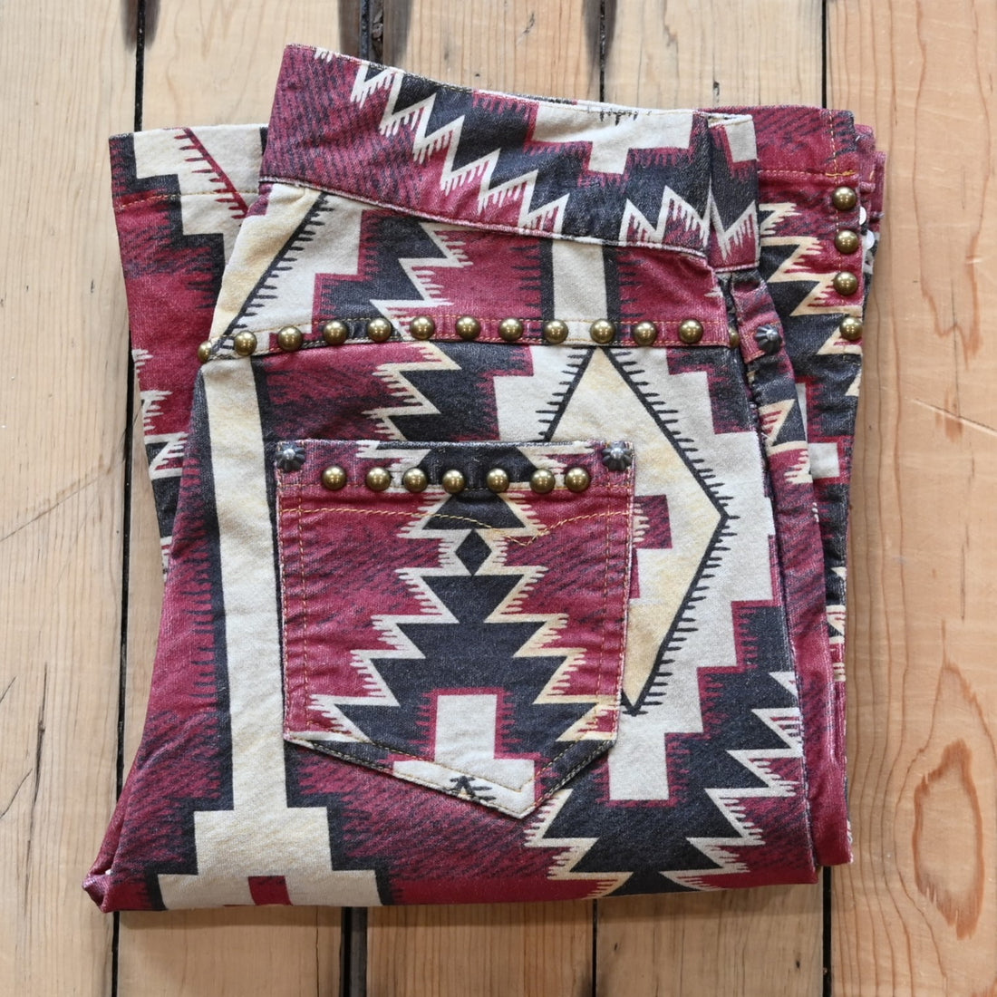 View of Double D Ranch Left Behind Pants – Traditional rug pattern with brass accents for a Western-inspired design