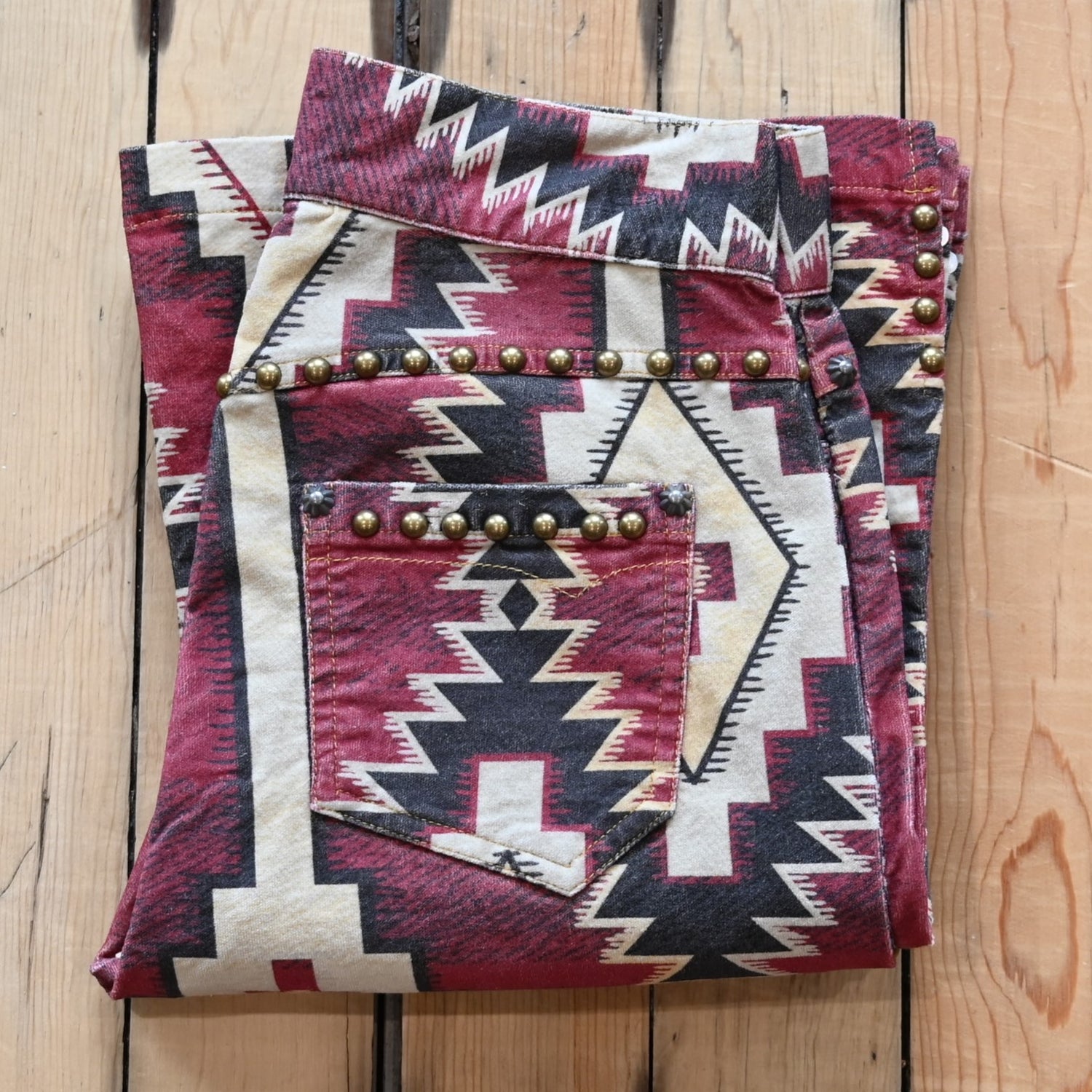 View of Double D Ranch Left Behind Pants – Traditional rug pattern with brass accents for a Western-inspired design