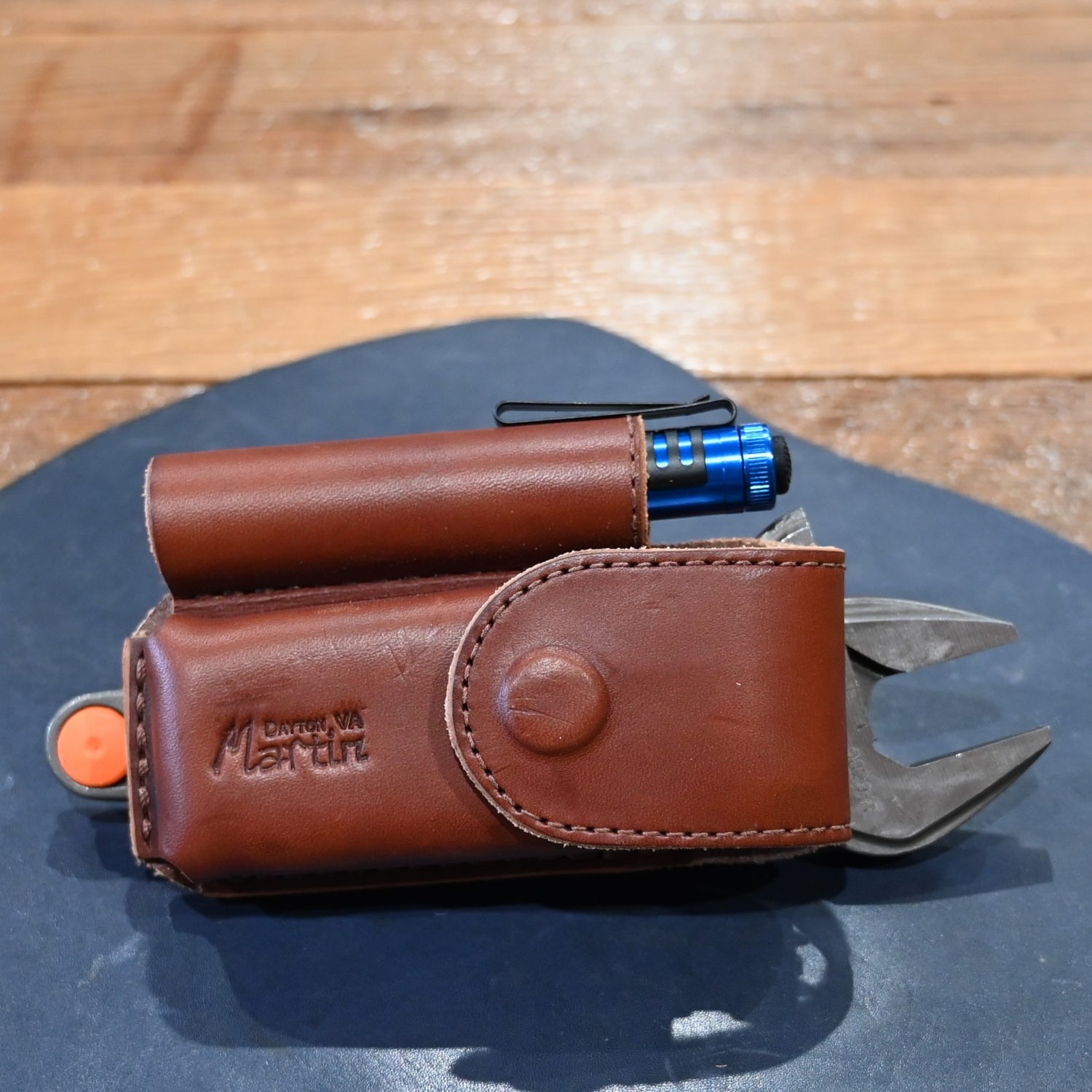 Martin harness leather case with flashlight, wrench, and Wave Leatherman tool combo