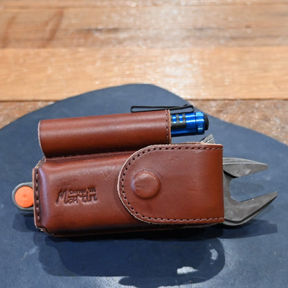 Martin harness leather case with flashlight, wrench, and Wave Leatherman tool combo