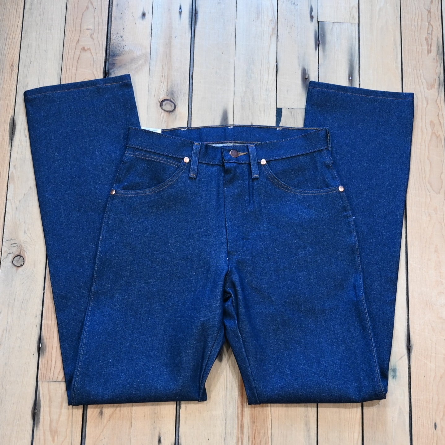 View of Wrangler Men’s Cowboy Cut Original Fit jeans in Prewashed Indigo with boot leg and five-pocket styling