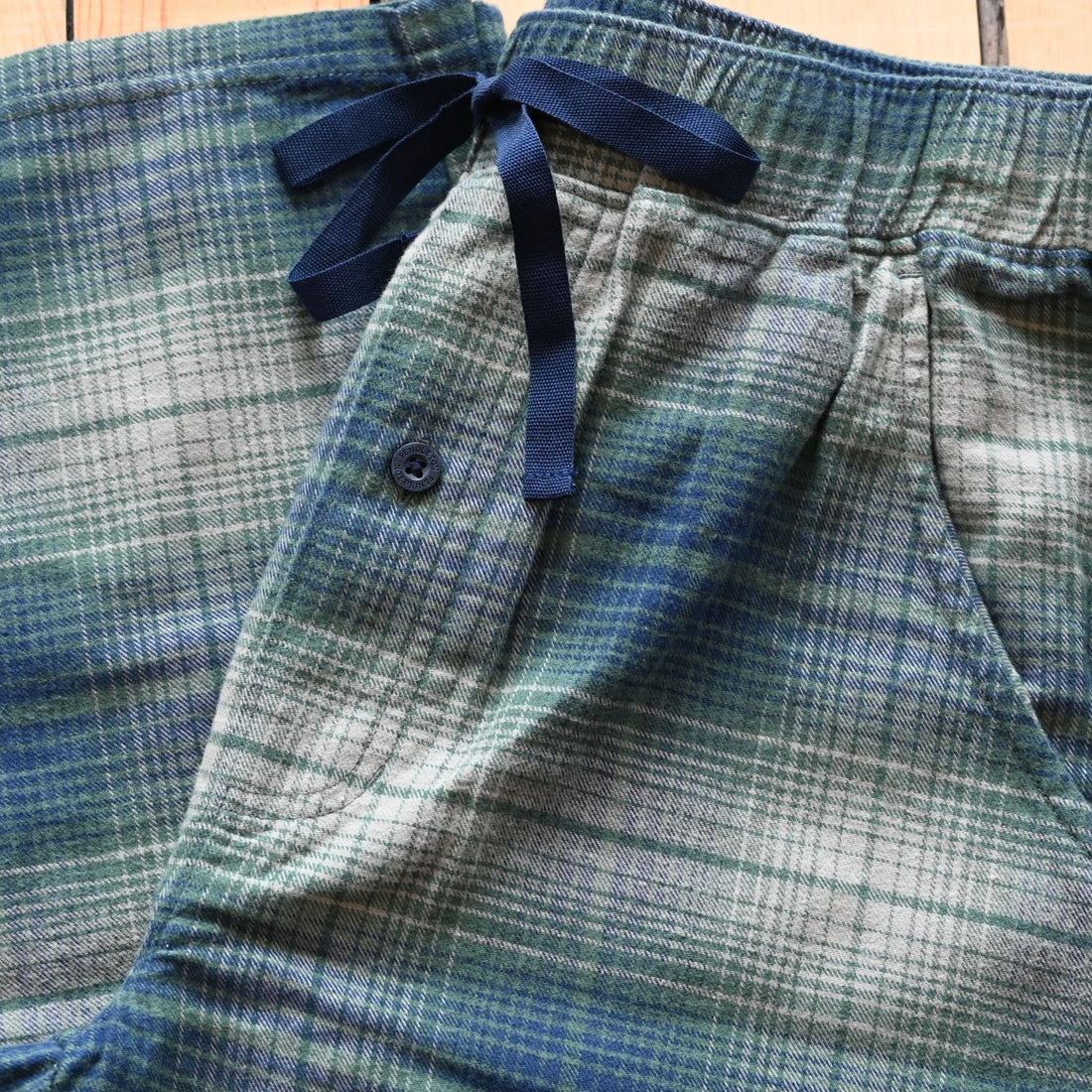 View of Pendleton men’s plaid cotton pajama pants in blue, green, and grey with elastic waist