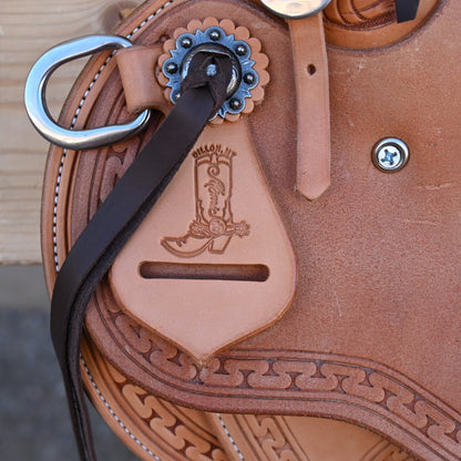 View of Deeter 3B Visalia Roughout Saddle with floral stamping and post horn