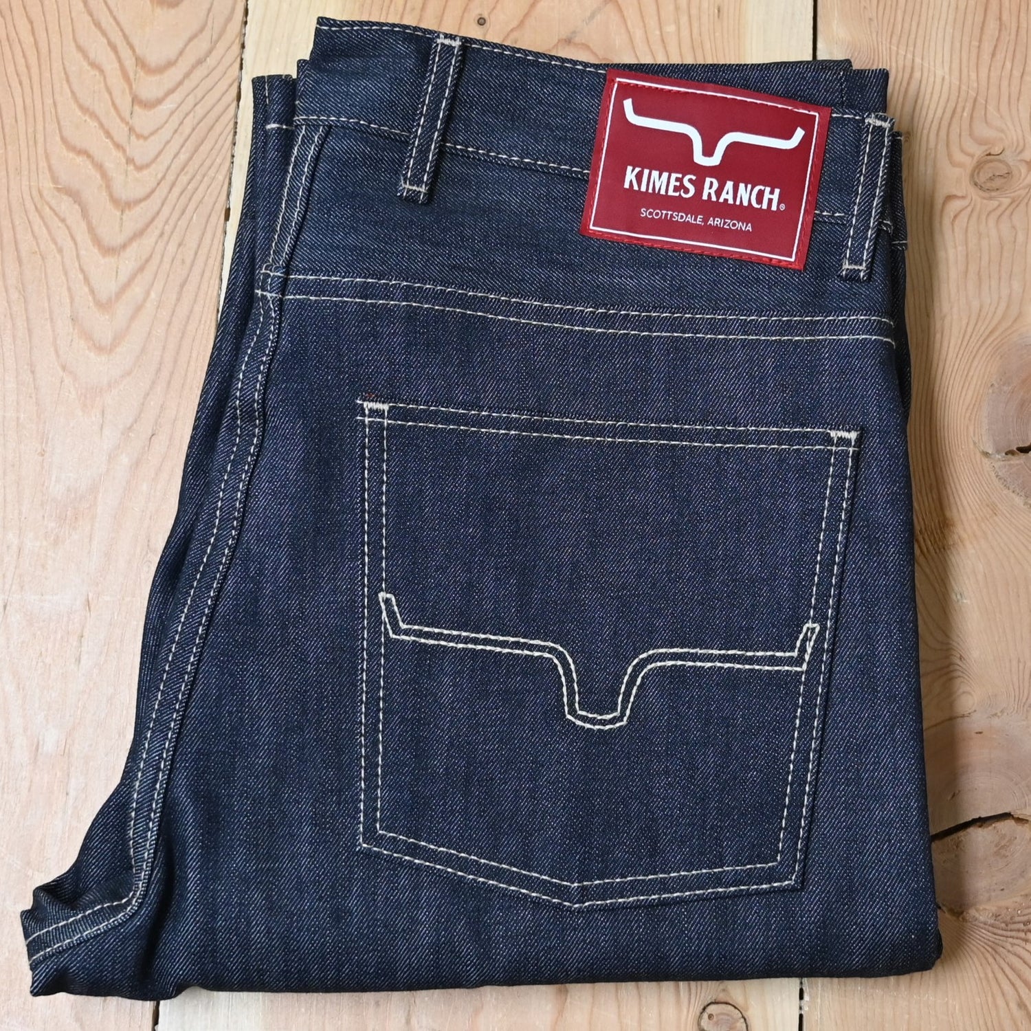 View of Kimes Ranch Raw James Jeans in Dark Indigo featuring integrated knife pocket and light stitching details.