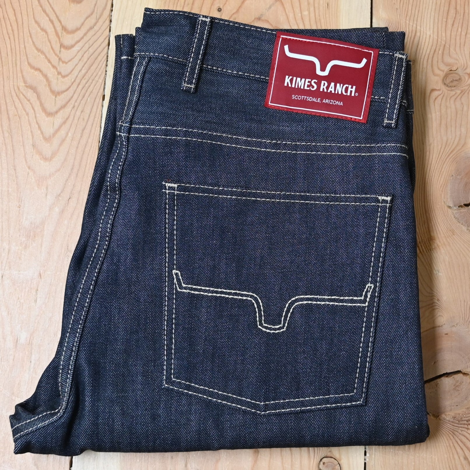 View of Kimes Ranch Raw James Jeans in Dark Indigo featuring integrated knife pocket and light stitching details.