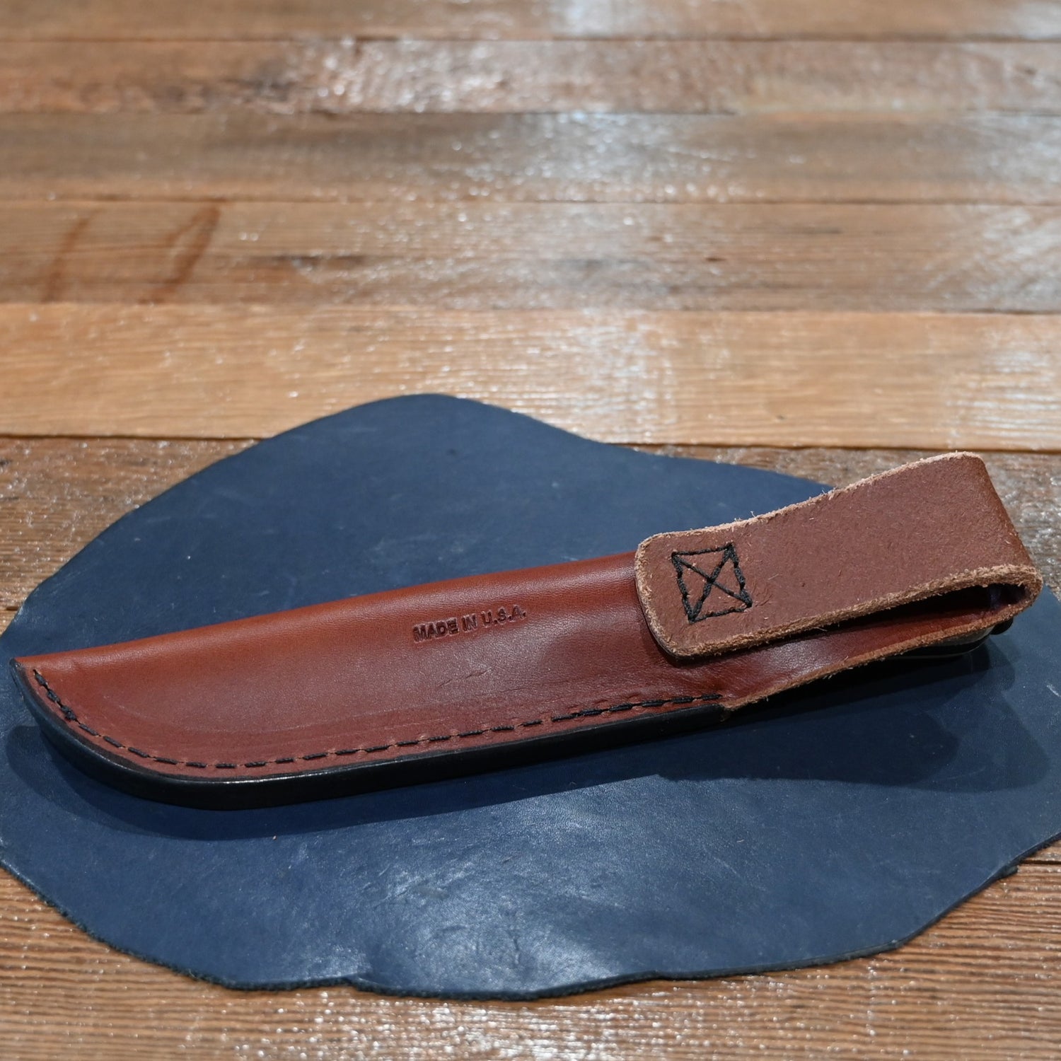 ESEE 4P knife with modified ergonomic handle and black leather sheath, 2025 edition